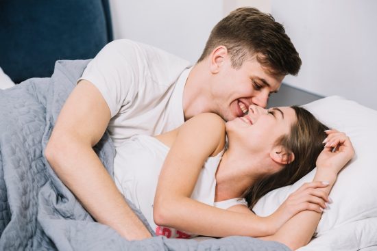 happy-man-hugging-woman-bed