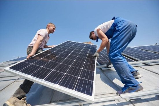 installing-solar-photovoltaic-panel-system-on-roof-2022-05-16-16-02-46-utc