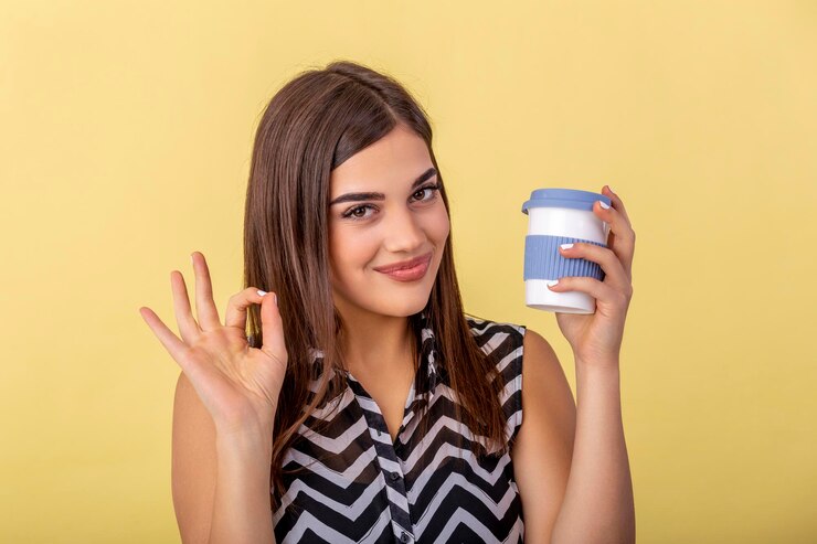 coffee-lover-concept-closeup-photo-portrait-delightful-cheerful-positive-with-toothy-beaming-smile-person-holding-cup-warm-latte-hands-cuddling-herself-isolated-bright-color-background_1212-4879