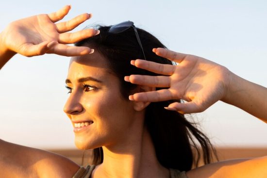 smiley-woman-outdoors-sun-covering-her-face_23-2148648085