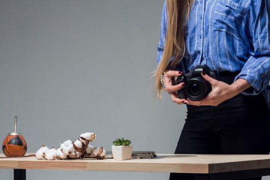 table-with-delicious-food-woman-holding-camera_23-2148424373 (1)