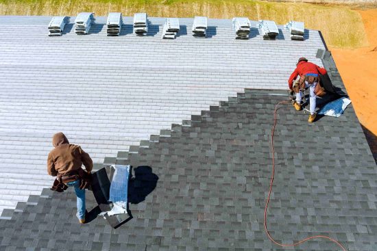 worker-hands-installing-bitumen-roof-shingles-with-2023-11-27-04-50-47-utc