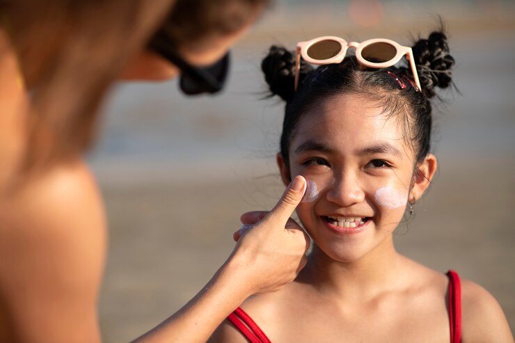 front-view-smiley-kid-with-sunscreen_23-2149631567