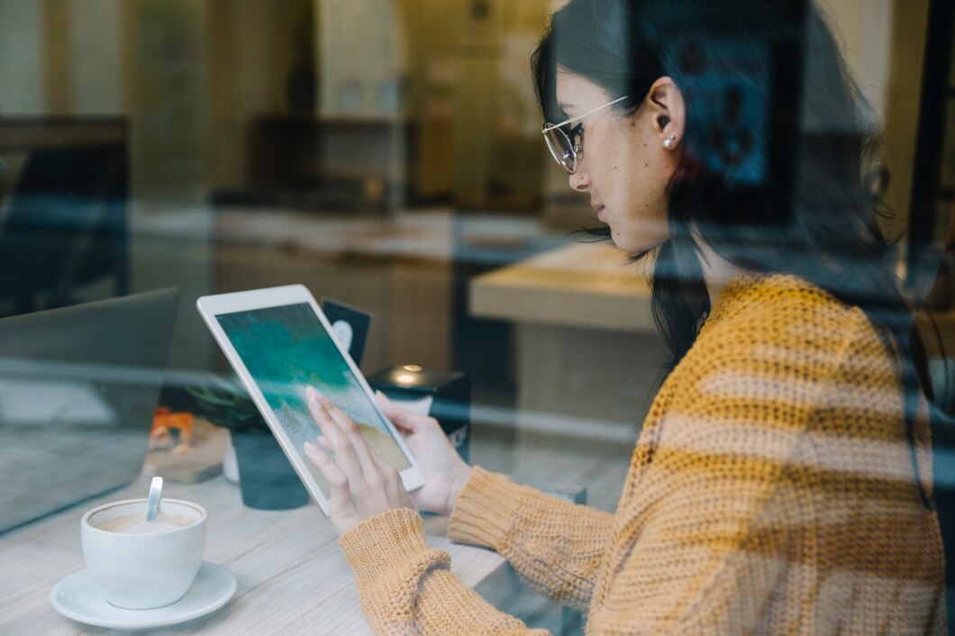 woman-with-coffee-tapping-tablet-screen_23-2147826848